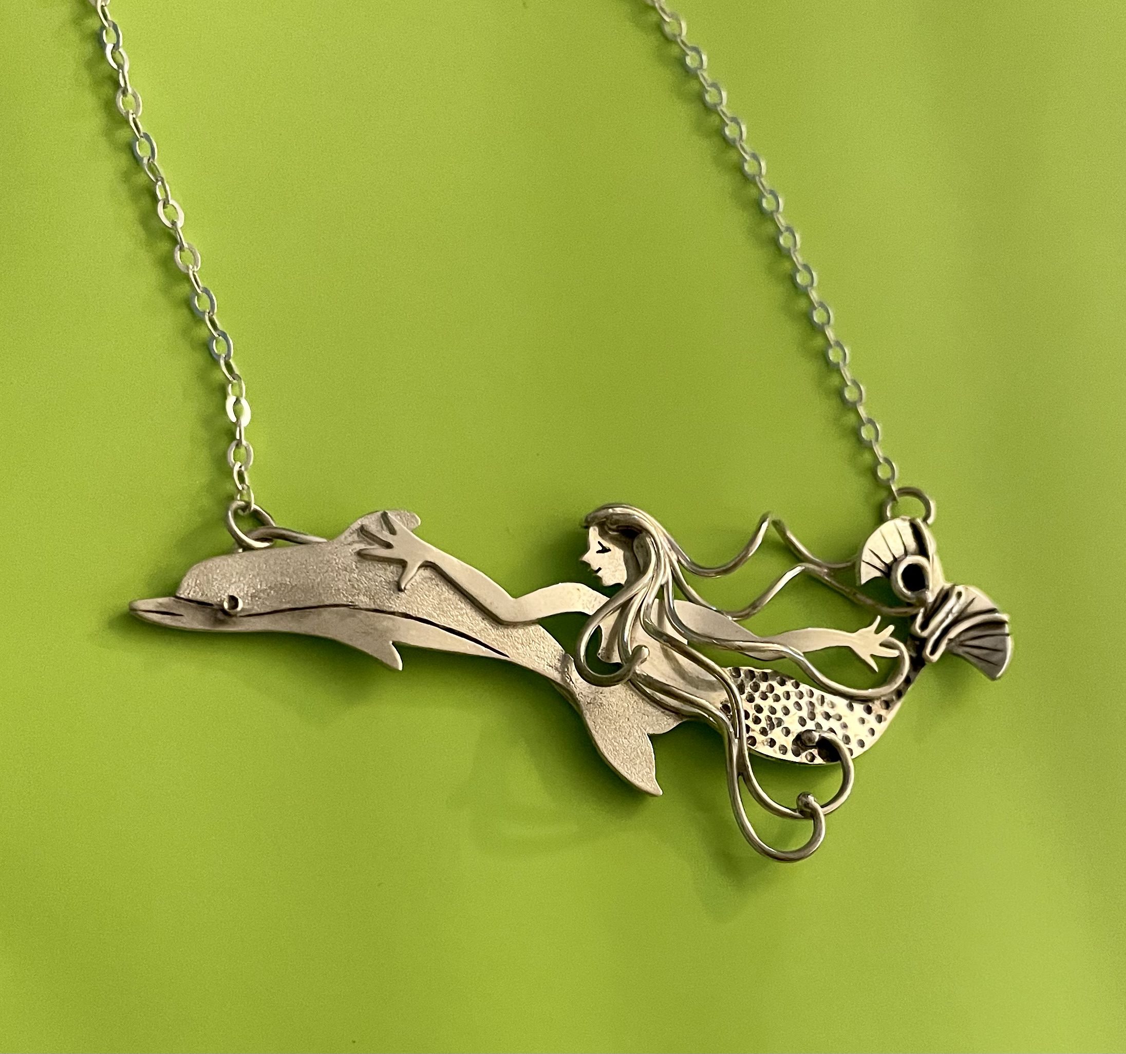Wild Ride, a mermaid swimming with a dolphin, in sterling silver